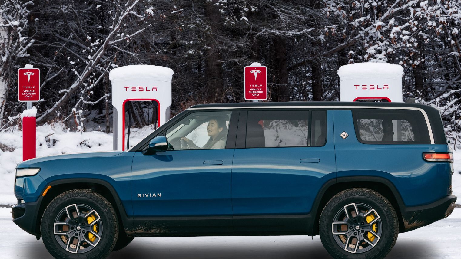 A fictional depiction of a blue Rivian R1S SUV alongside two Tesla Supercharger stalls.