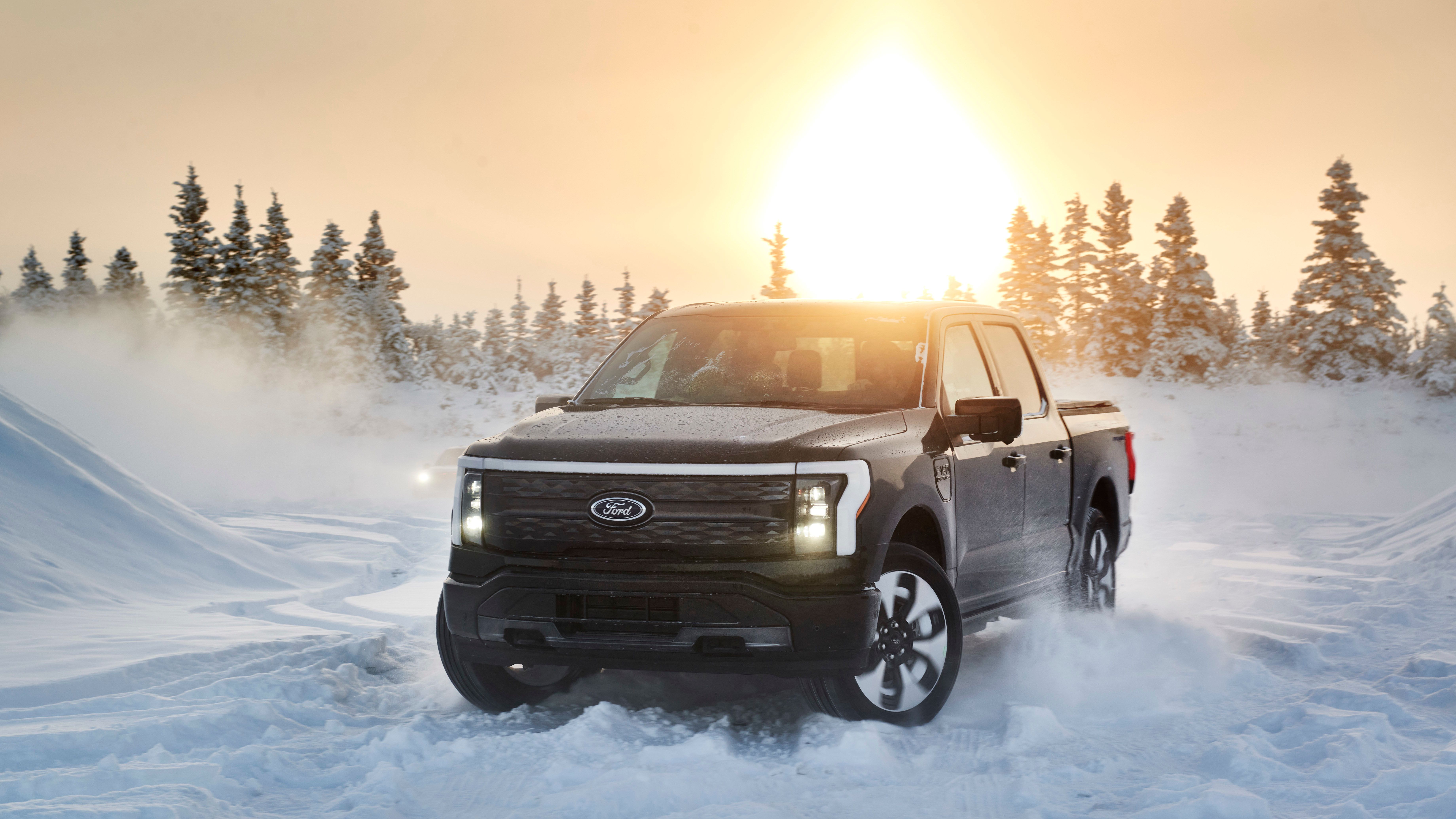 2022 Ford F-150 Lightning testing in snowy Alaska with the sun behind it.