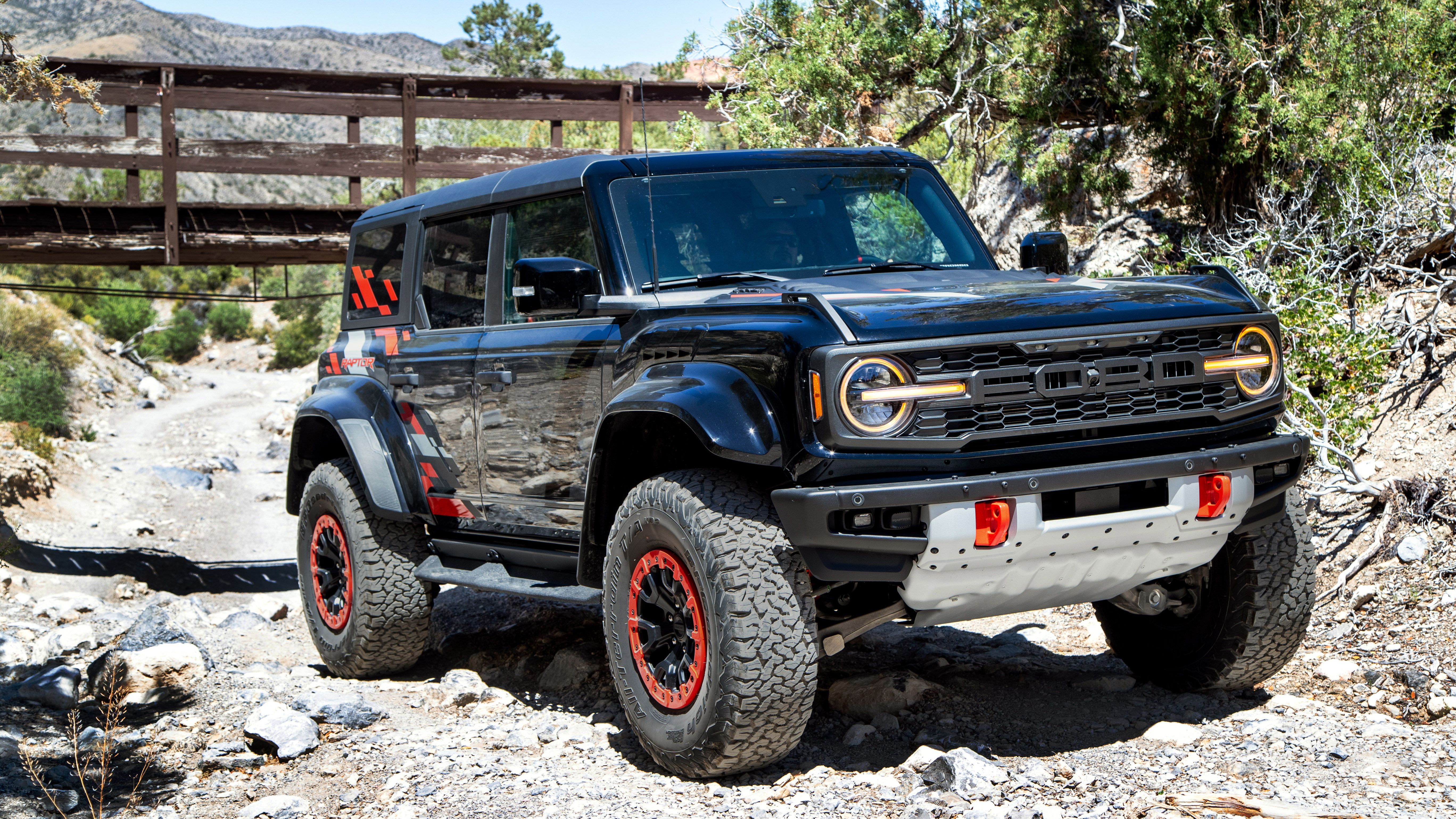 2024 Ford Bronco Raptor front three-quarter view on rocky road.