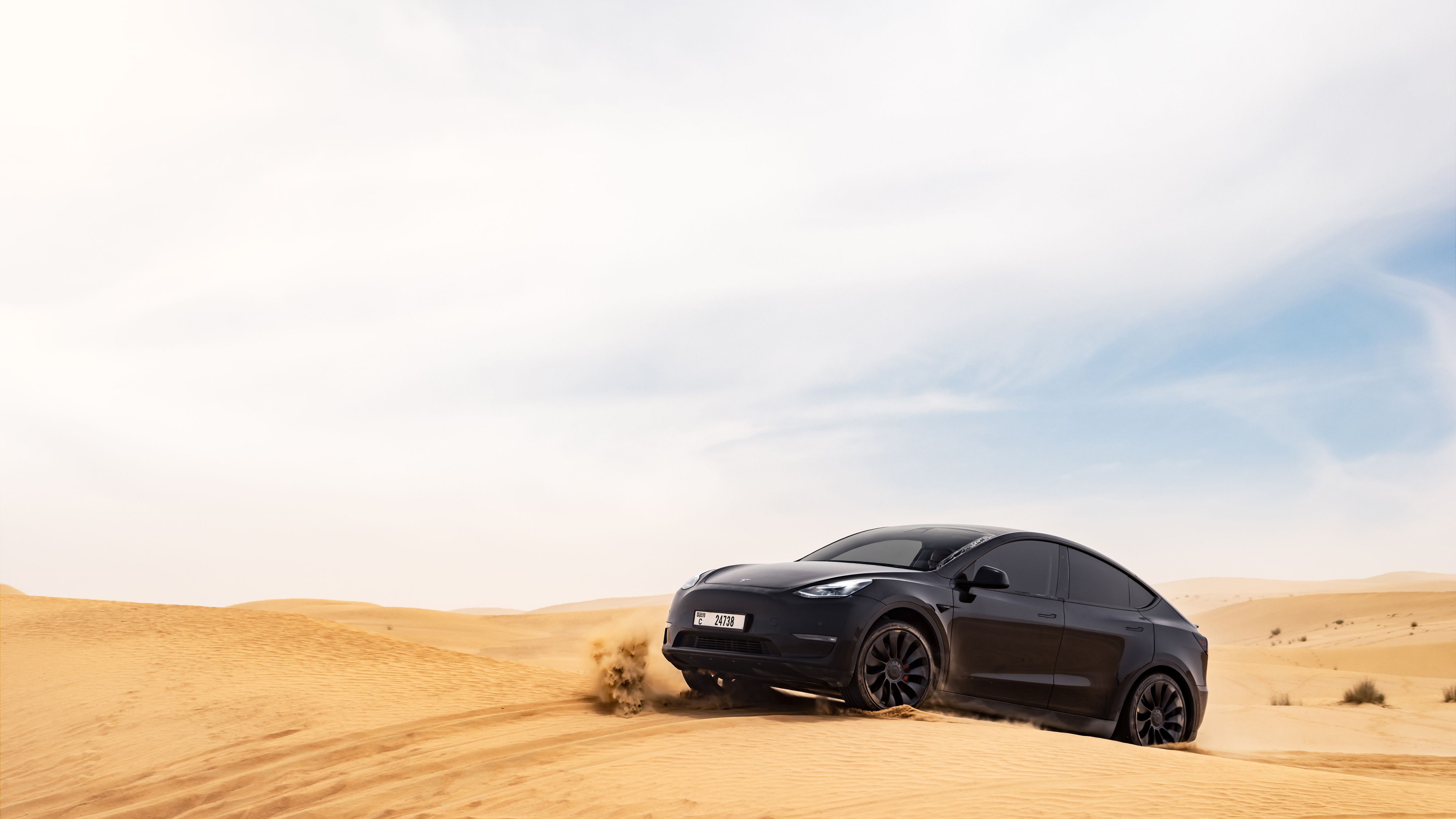 Black Tesla Model Y in the desert.