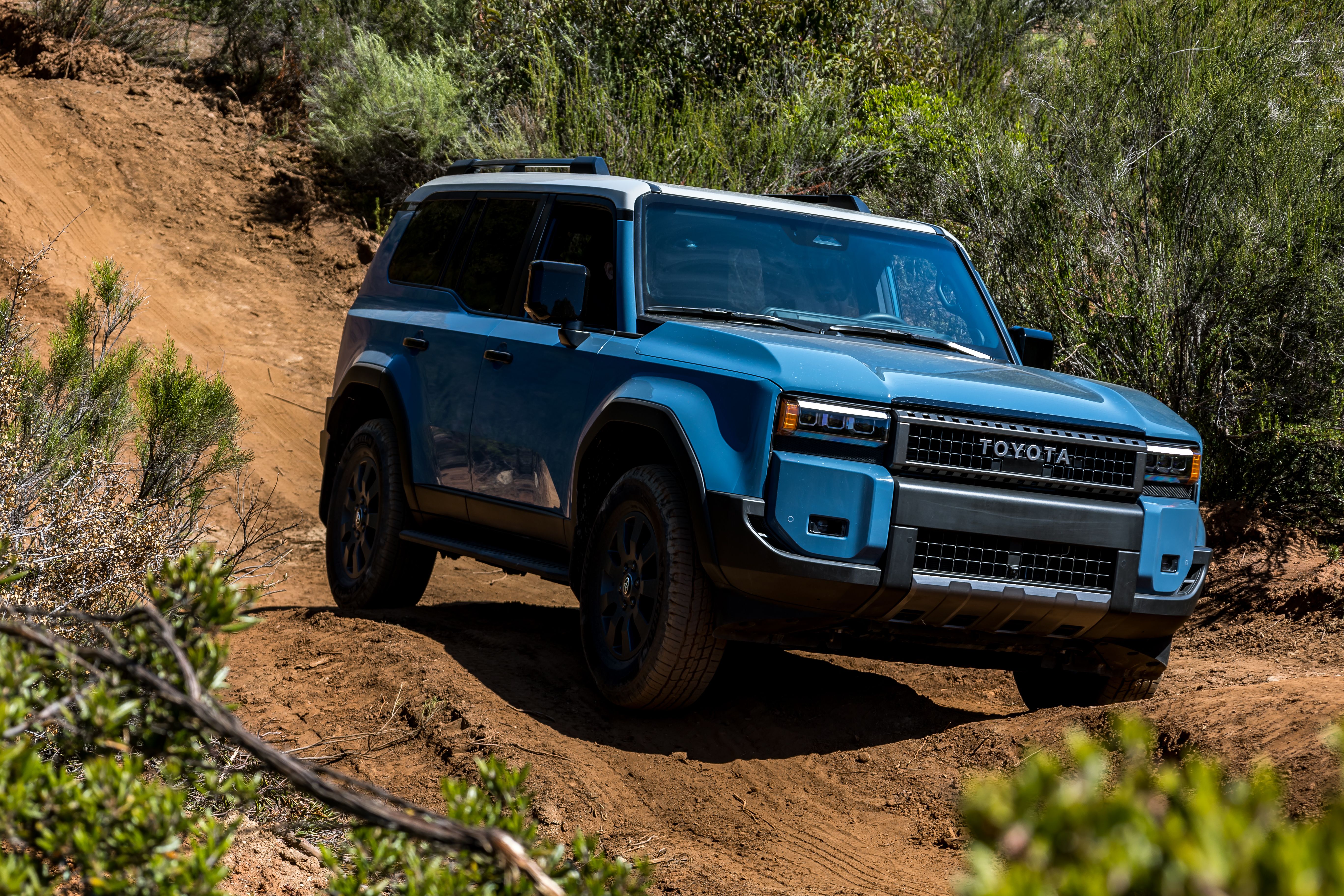 2024 Toyota Land Cruiser Blue Exterior Shot Climbing Rocks