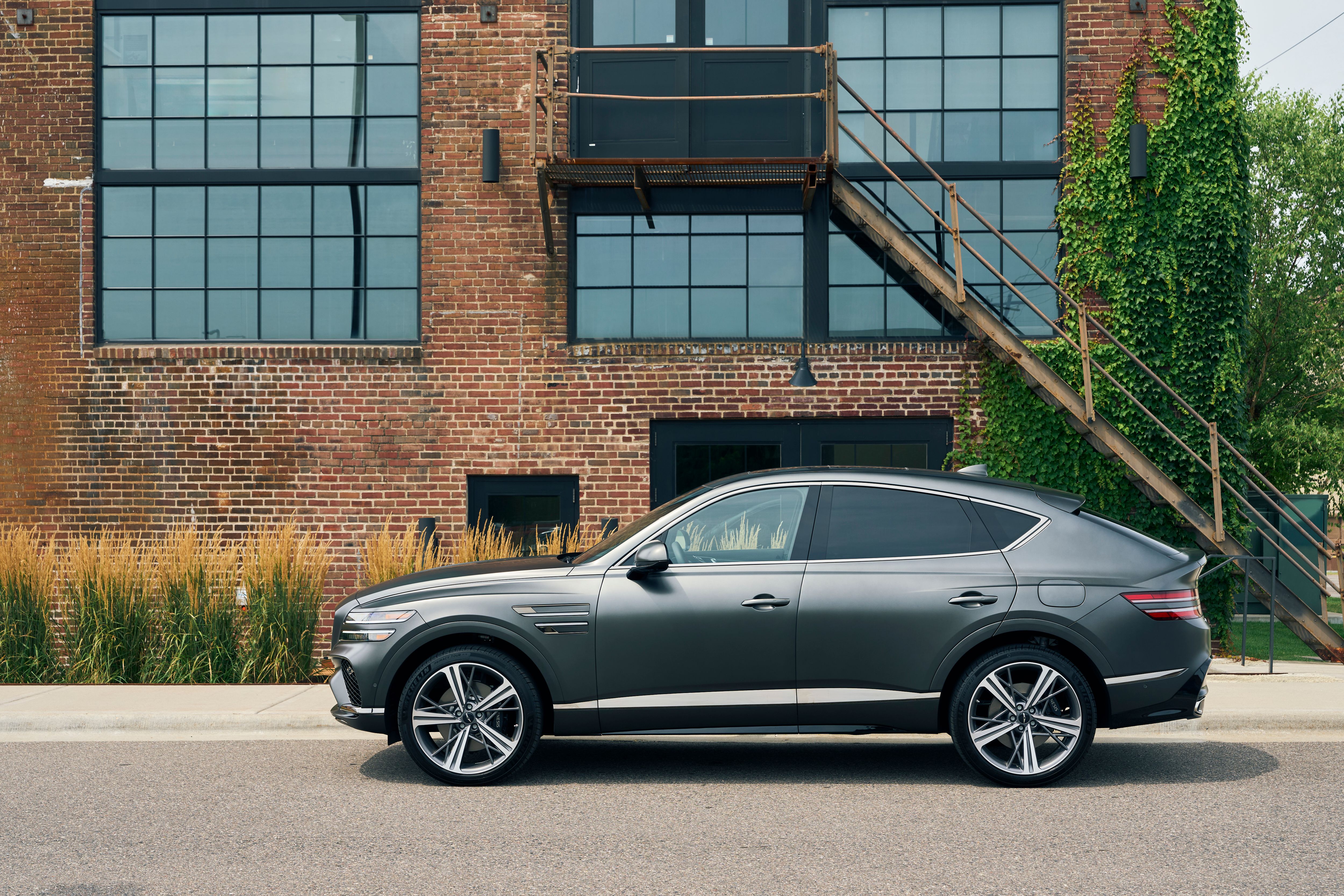 The 2025 Genesis GV80 Coupe in profile by a brick wall