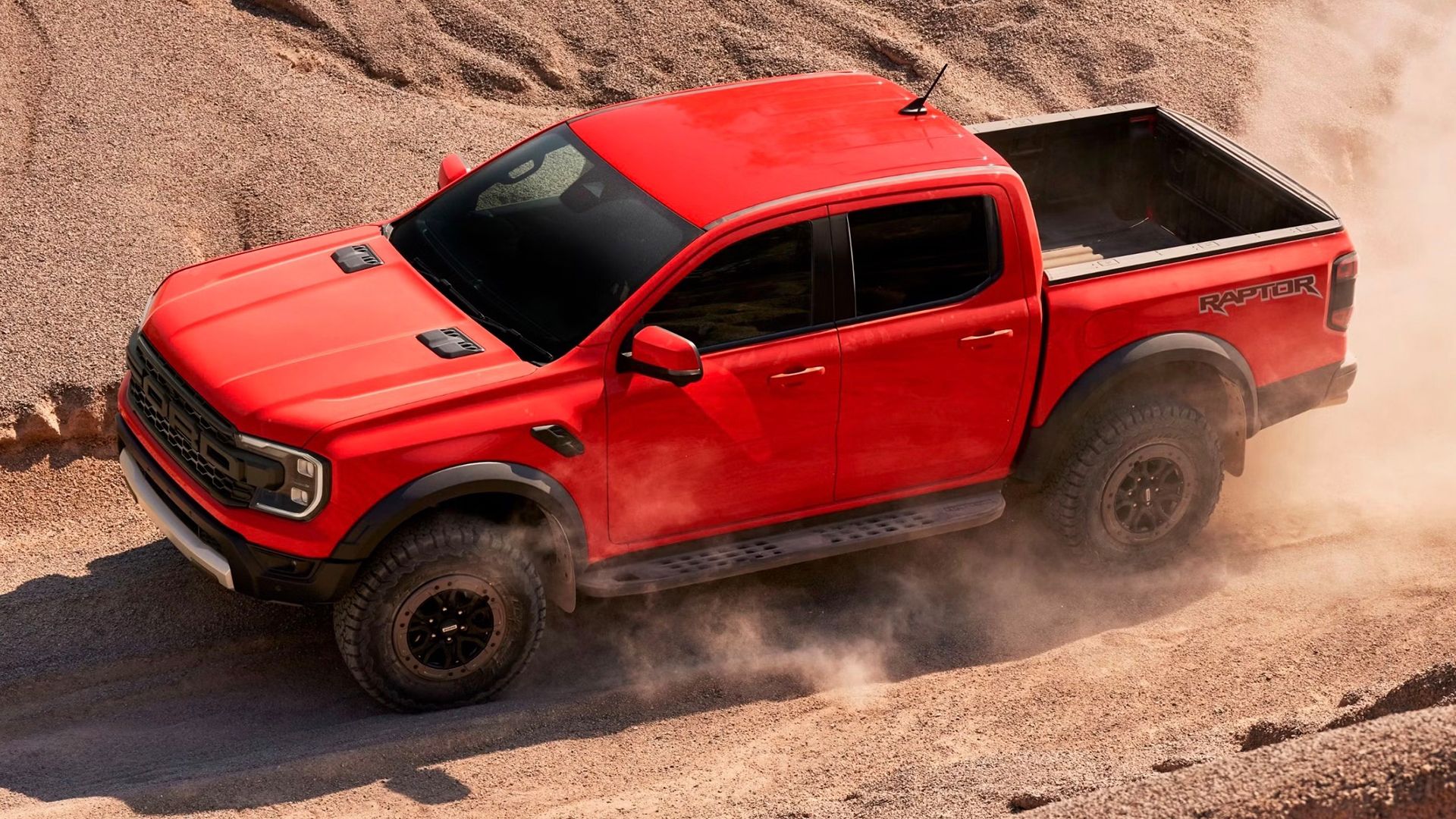 2025 Ford Ranger Raptor Orange High Front Angled View Dirt Driving