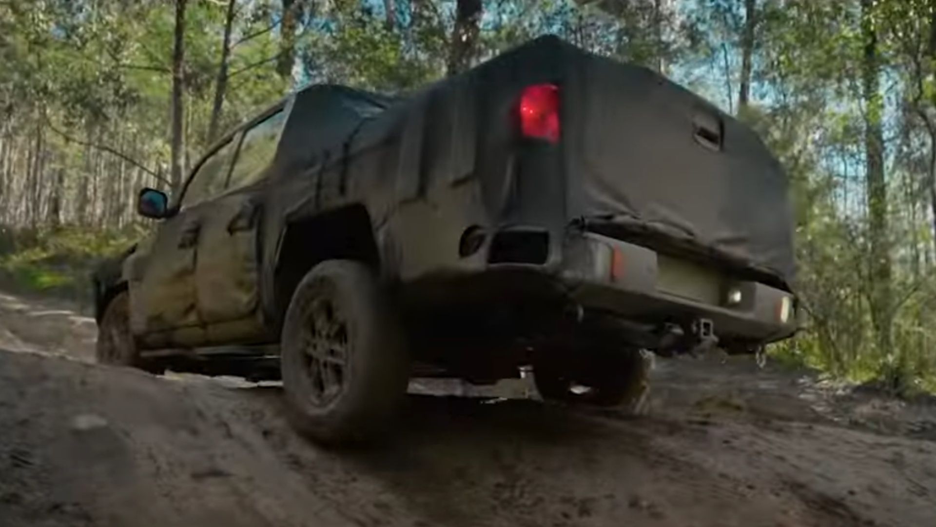 The rear of a camouflaged Kia Tasman