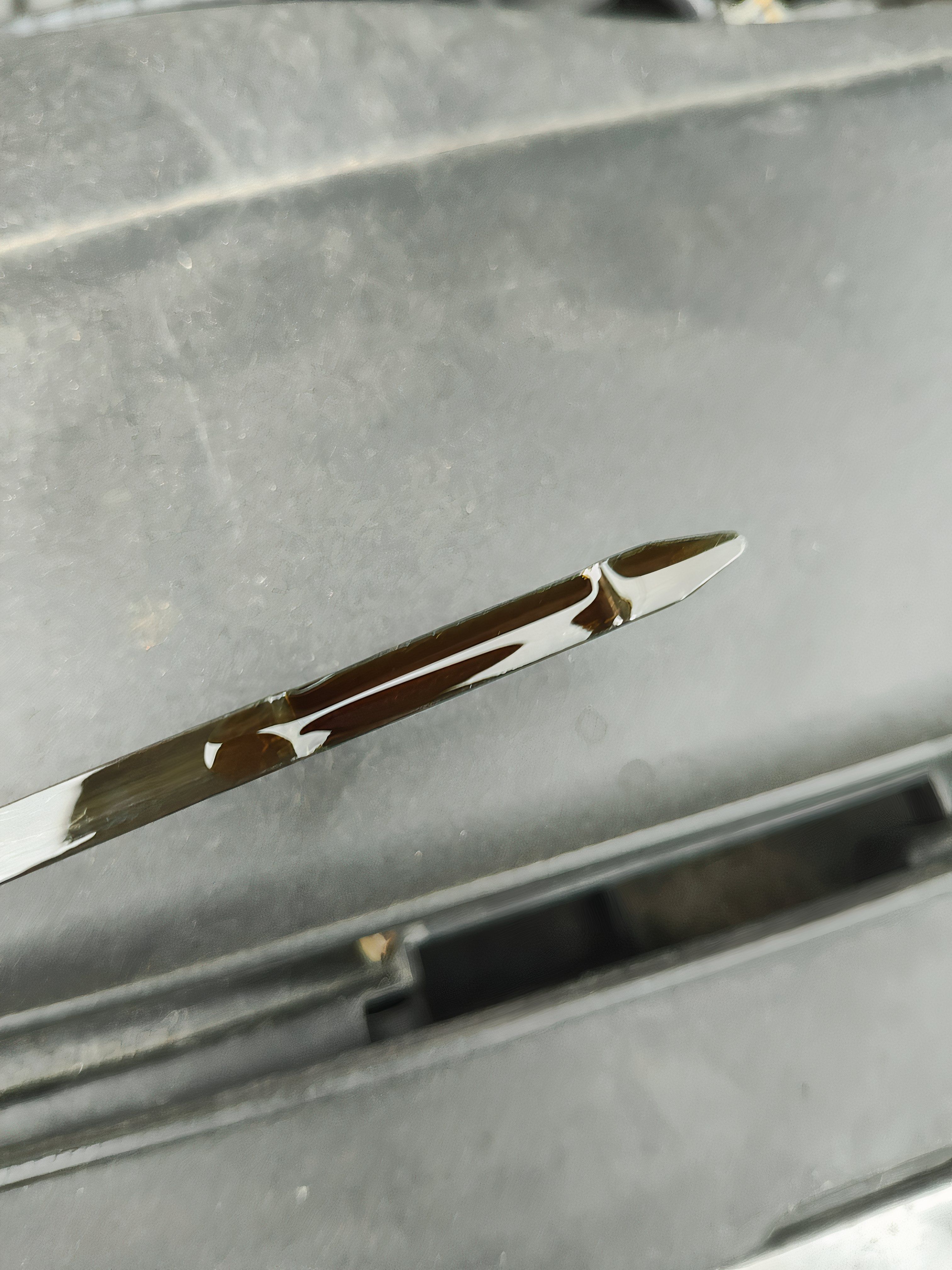 Overfilled engine oil dipstick