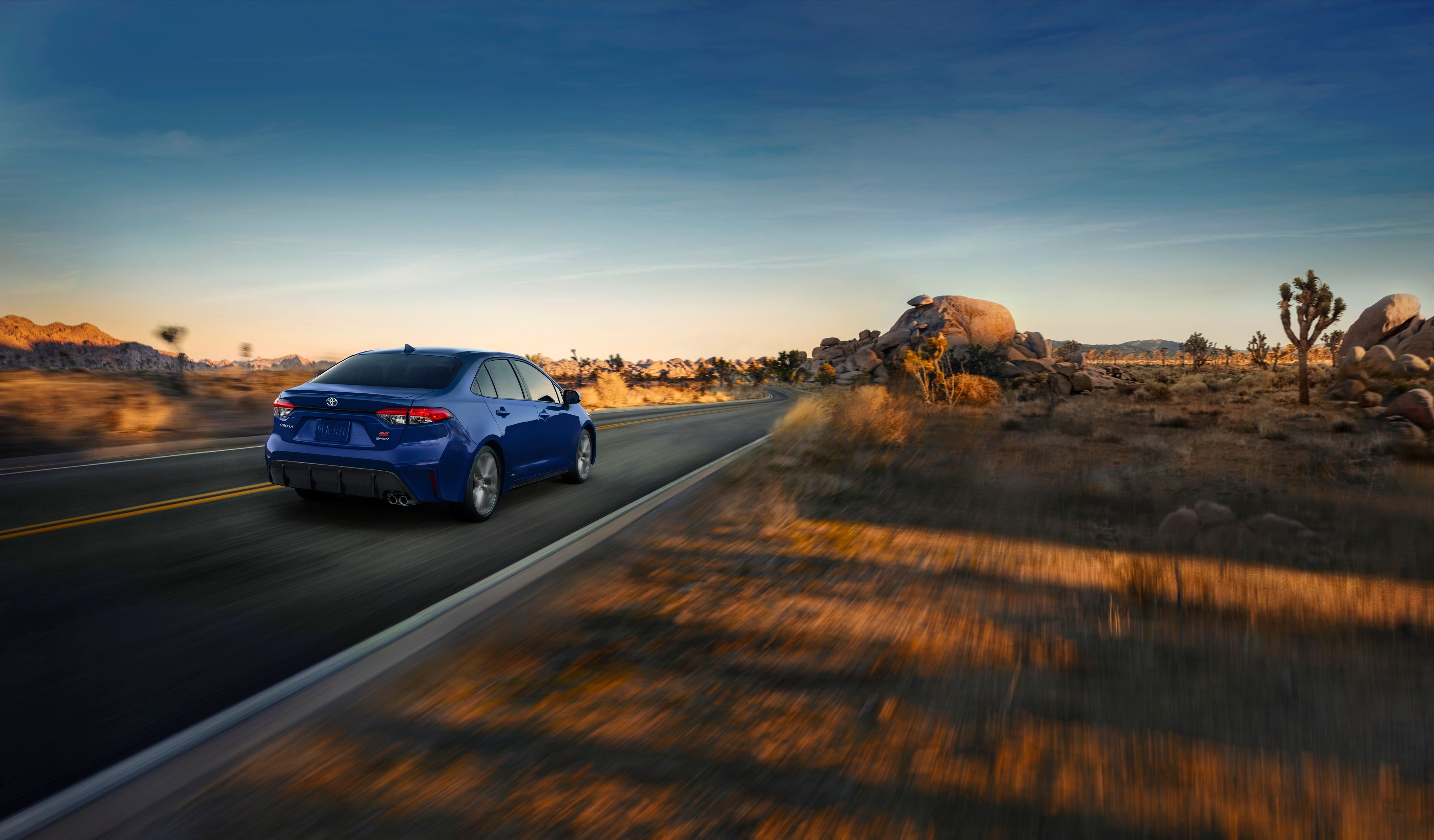 2025 Toyota Corolla Hybrid, rear angle driving