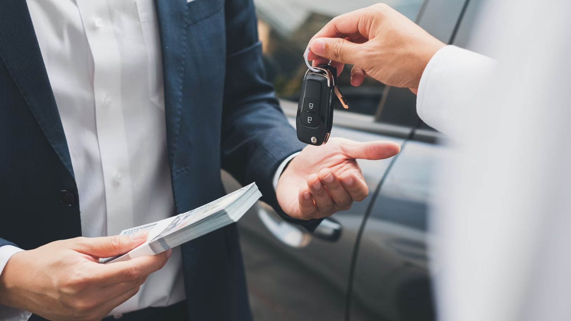 A Guy Buying Car With A Stack Of Cash