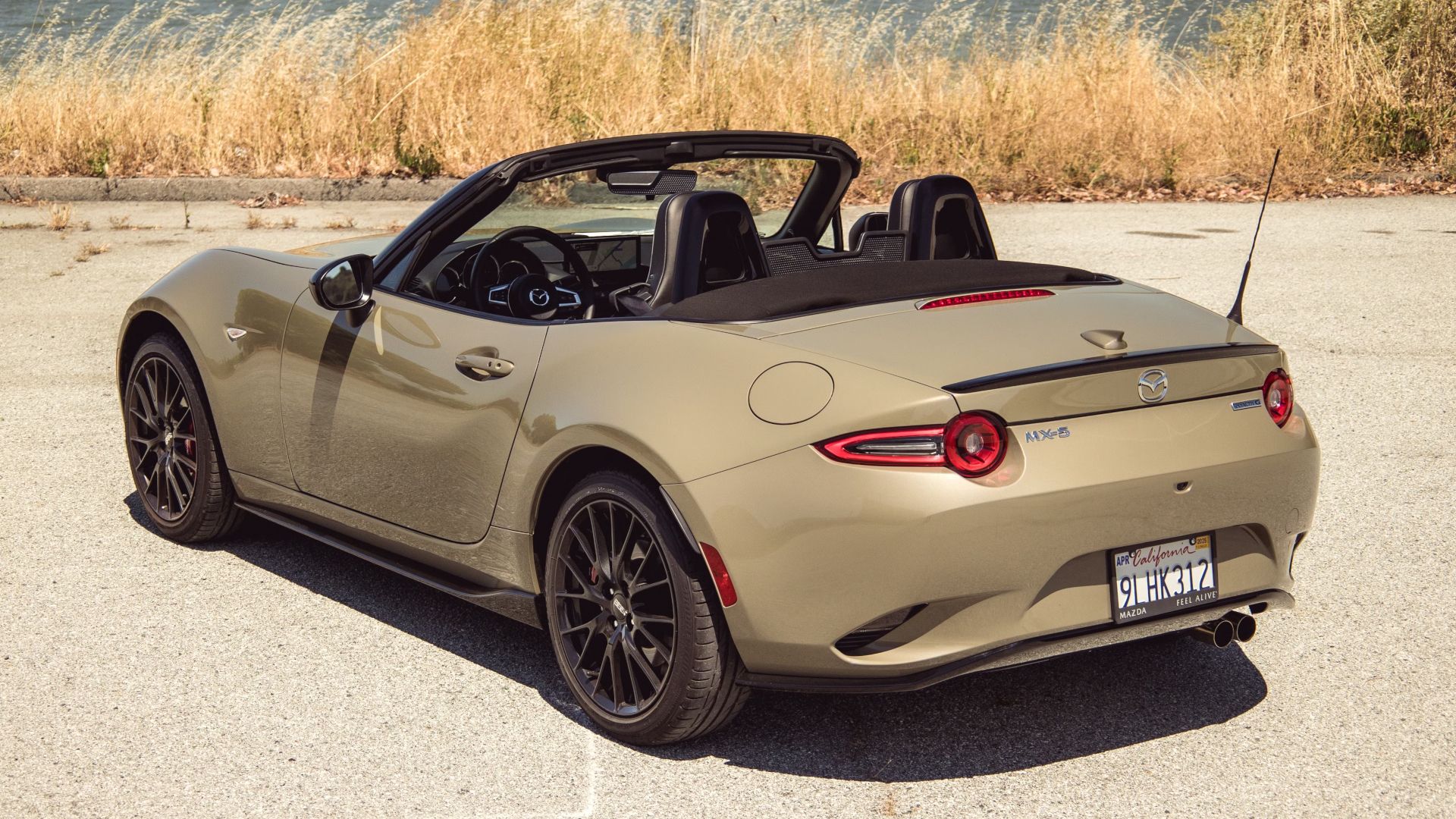 2024 Mazda MX-5 Miata Roof Down Gold Rear Angle