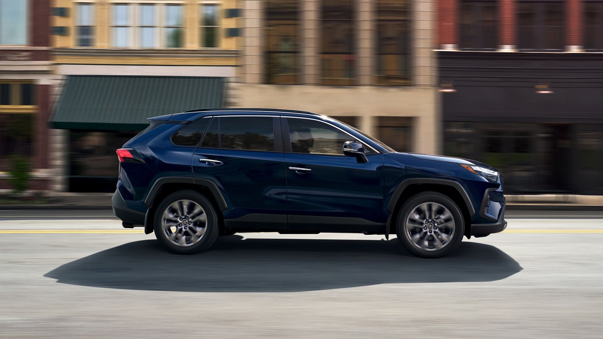 2025 Toyota RAV4 Blue Side Driving