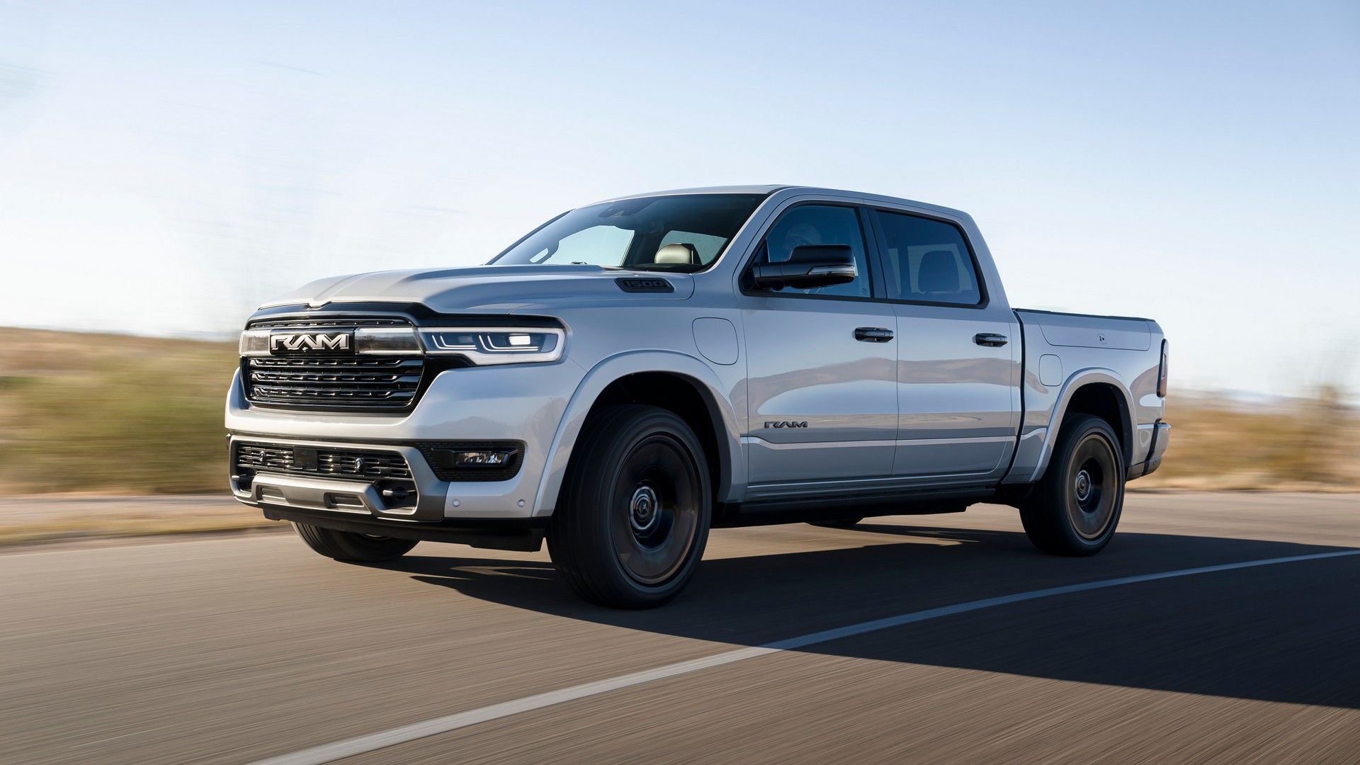 2026 Ram 1500 Ramcharger Silver Front Angled View Driving