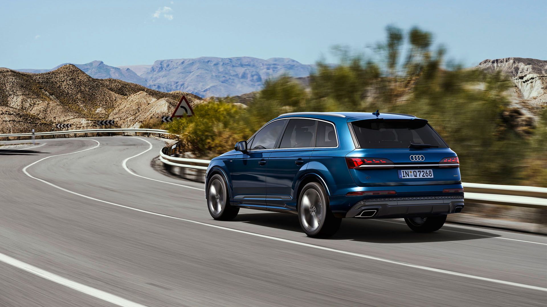 2025 Audi Q7 driving on a currvy mountain road.