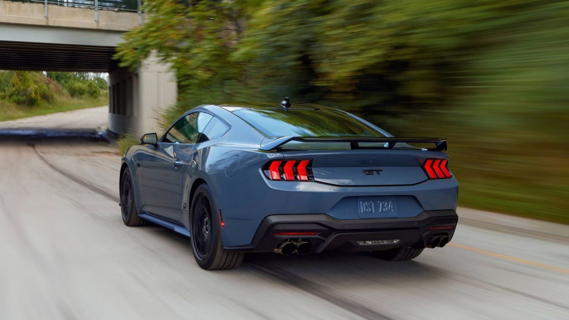 2025 Ford Mustang GT Coupe Blue Rear Angle Driving
