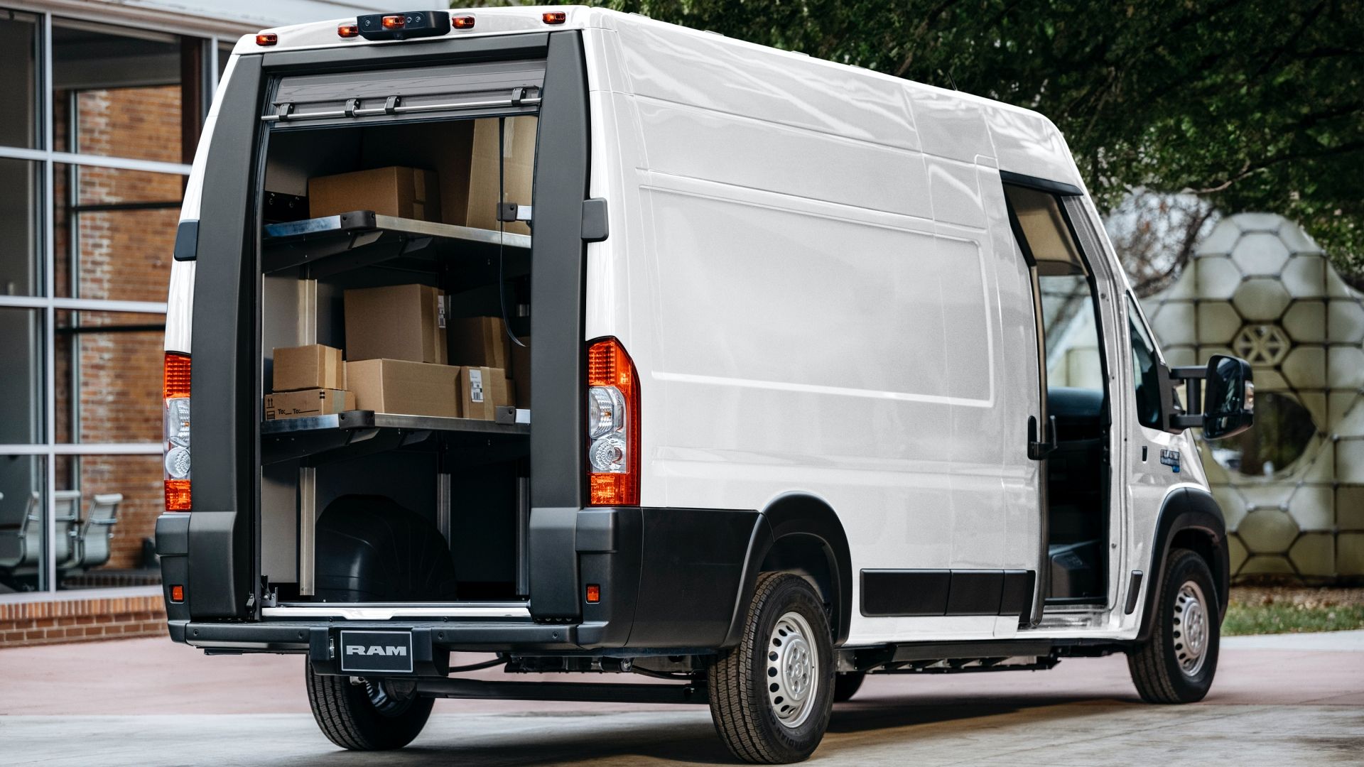 A white Ram ProMaster EV step van parked on a road.