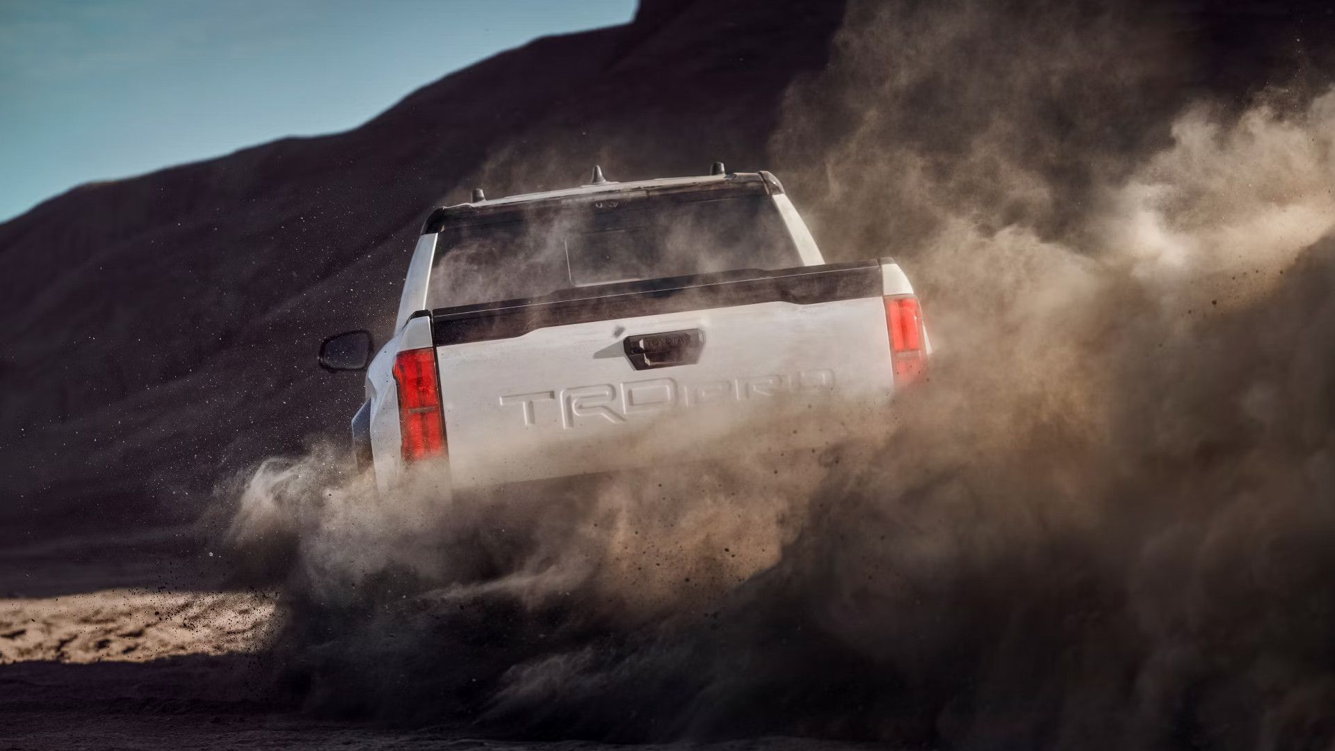 2025 Toyota Tacoma White Rear Sand Driving