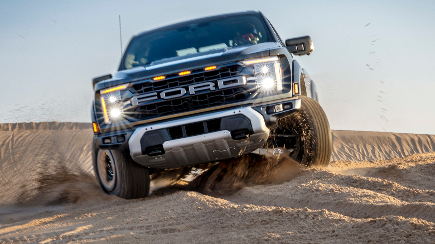 2024 Ford F-150 Raptor Black Front View Sand Driving