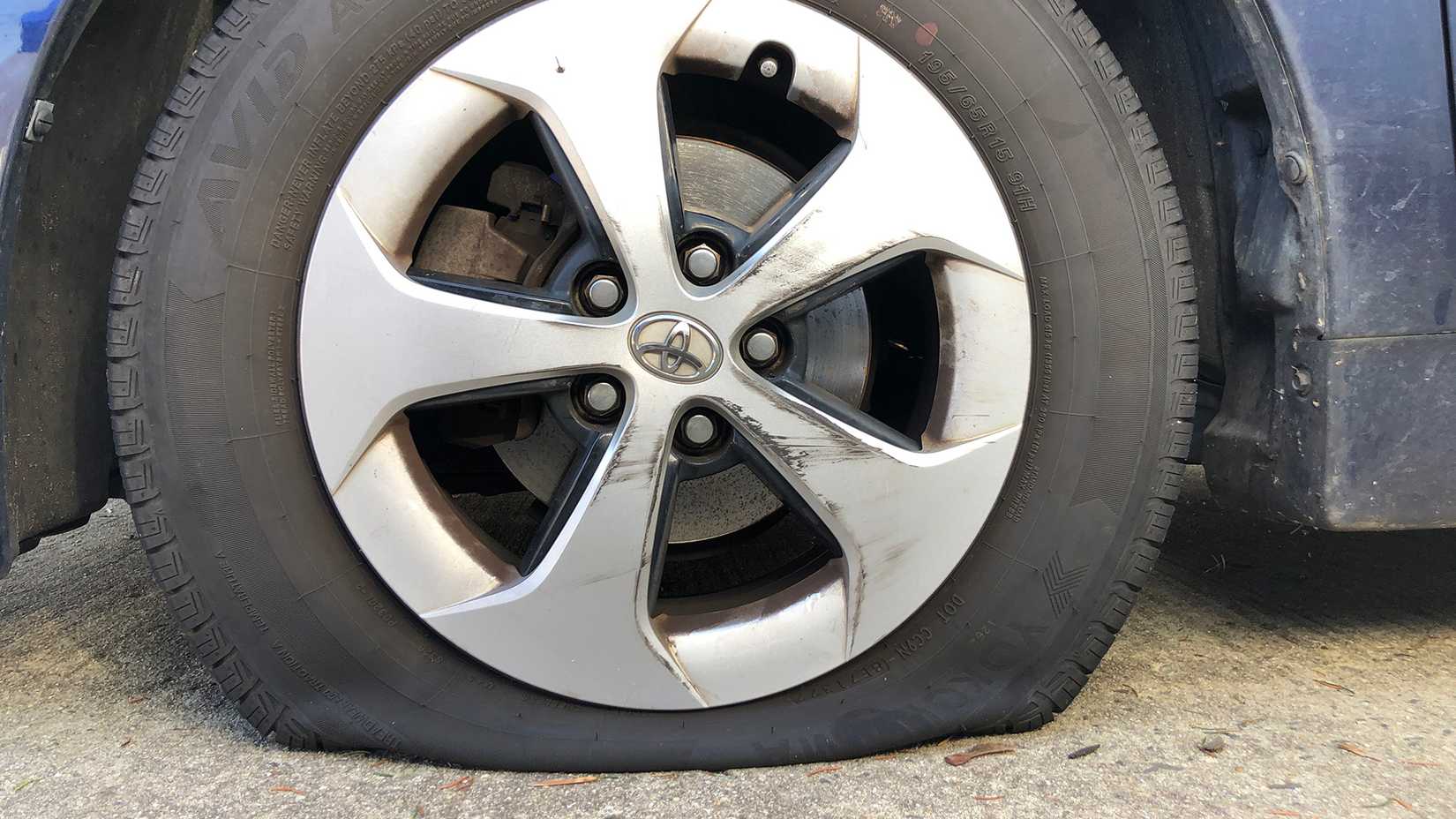 Flat tire with damaged wheel