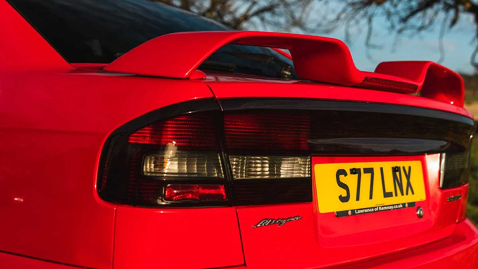 Red 2000 Subaru Legacy Blitzen tail