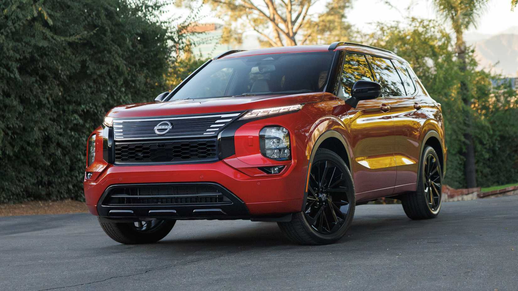 Featured image of the 2026 Nissan Rogue Plug-In Hybrid driving on a coastal road, highlighting its aerodynamic profile and LED lighting