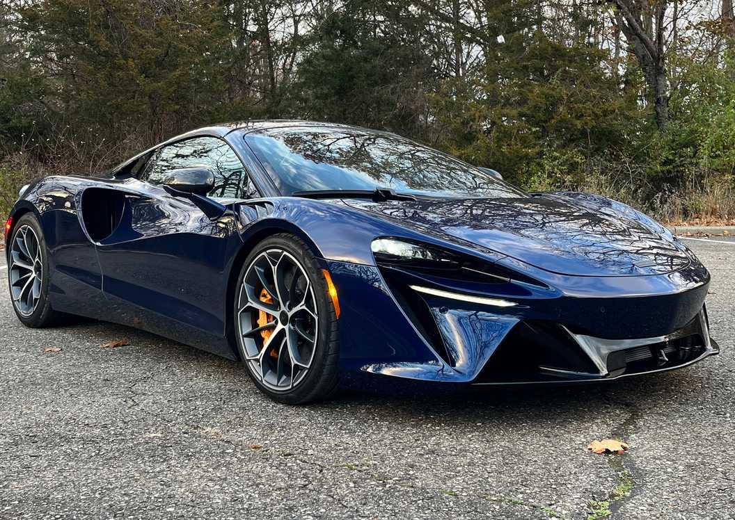 A McLaren supercar on display at an automotive showcase with sleek body lines visible