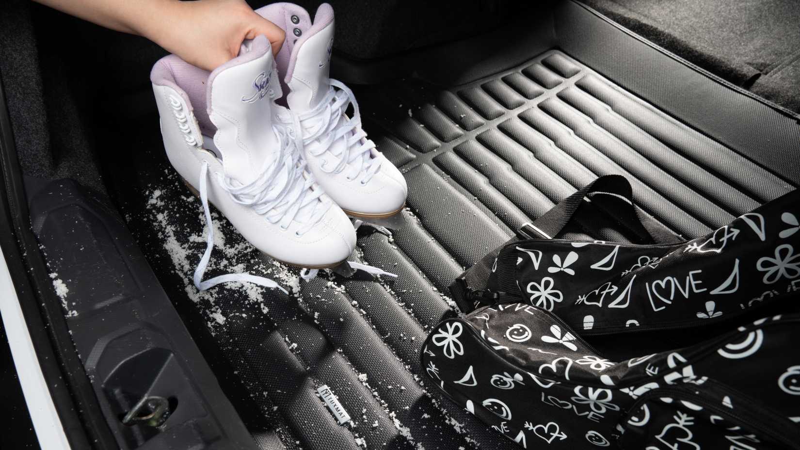 Snow boots and mittens on Tuxmat premium floor mats.