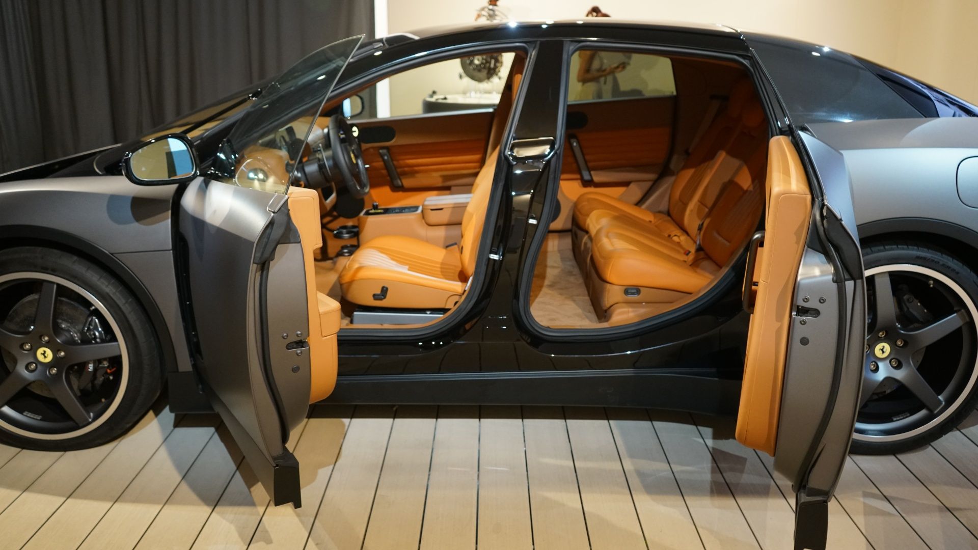 Ferrari Luce interior showing the minimalist cabin with analog-digital instrument cluster and pivoting centre screen