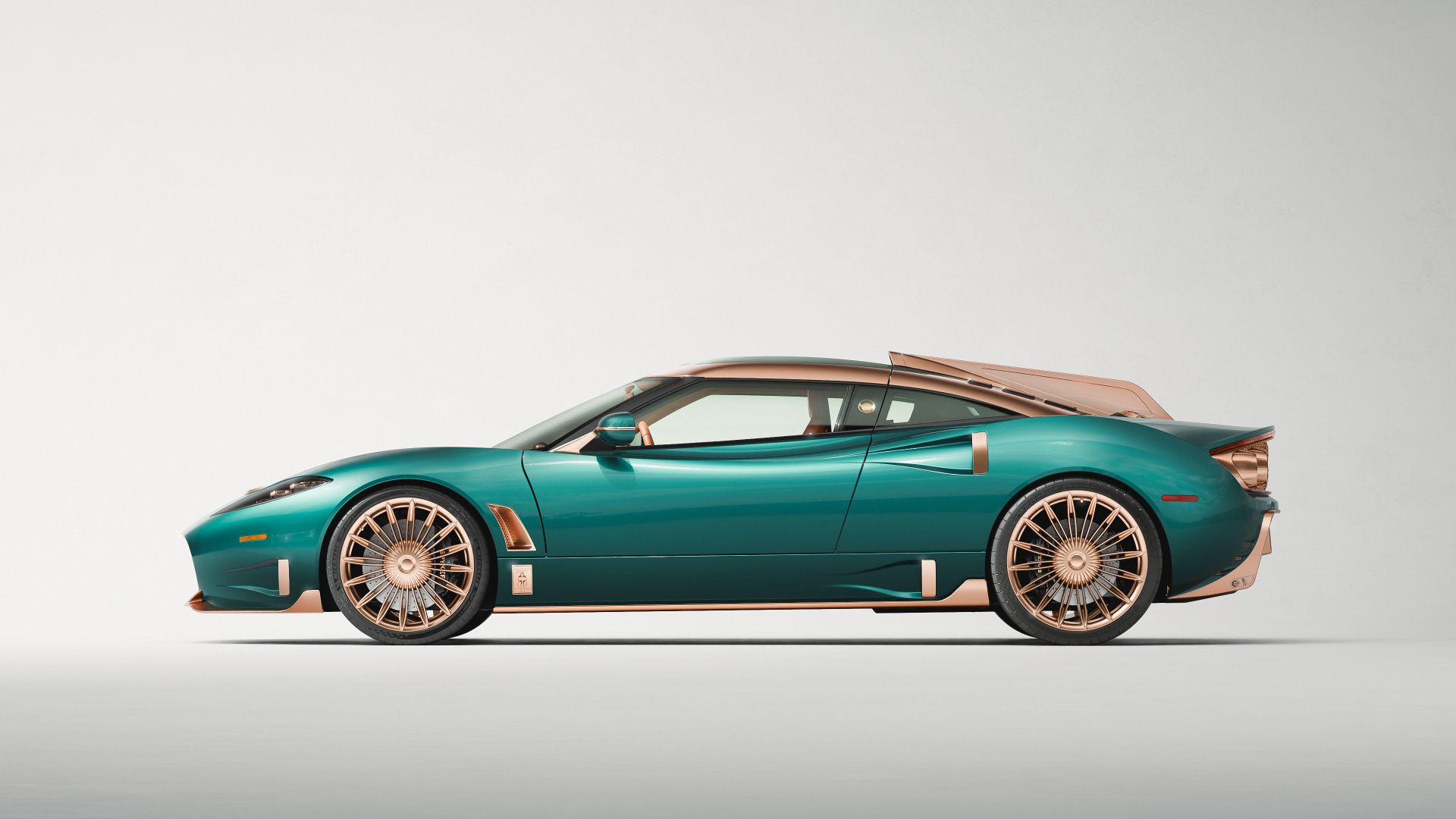 Spyker C8 Preliator XXV side profile in Quail Green metallic with rose gold accents at Monterey Car Week