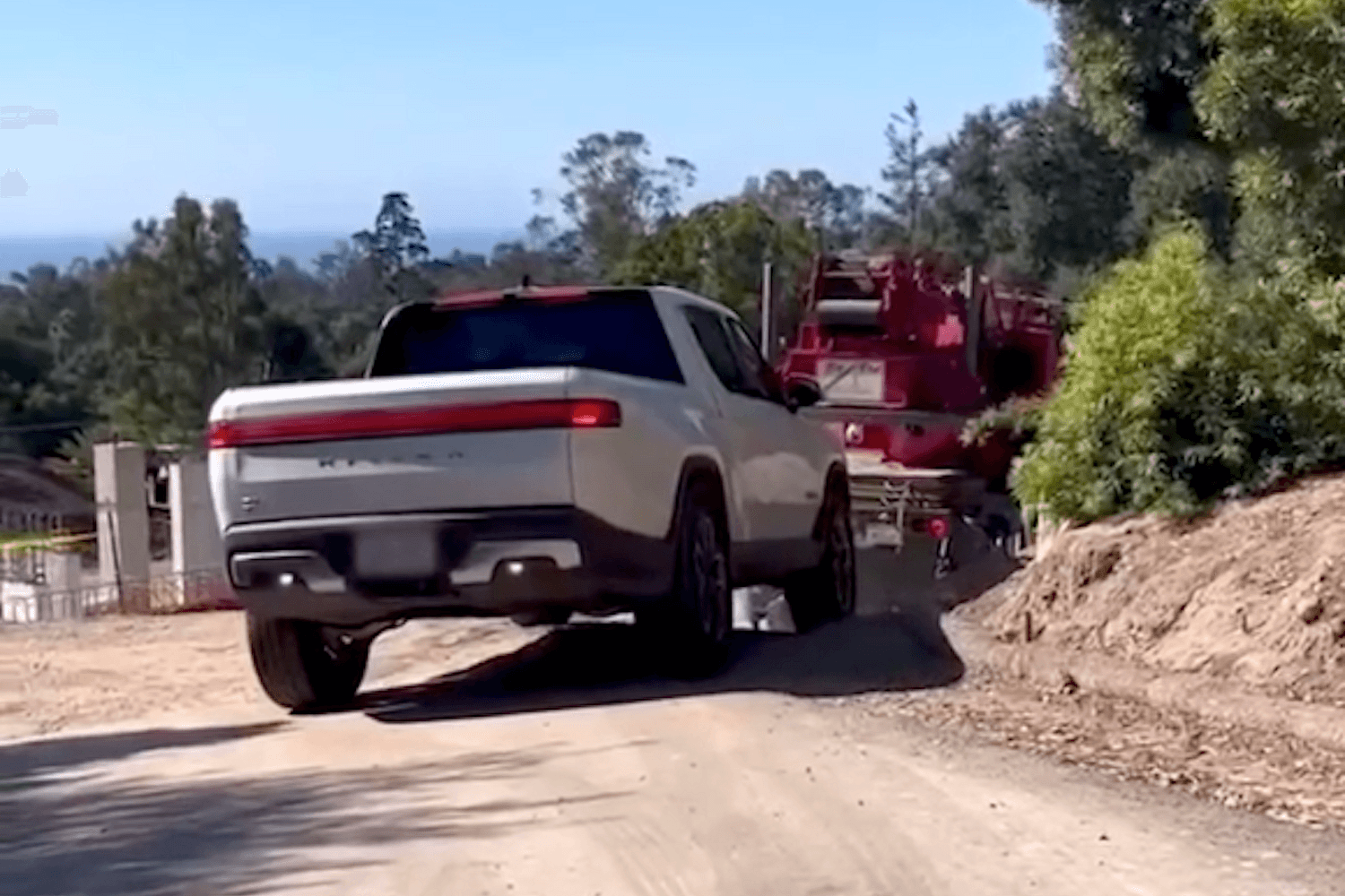 WATCH: Rivian R1T Pulls Stuck Heavy Machinery Out Of A Ditch